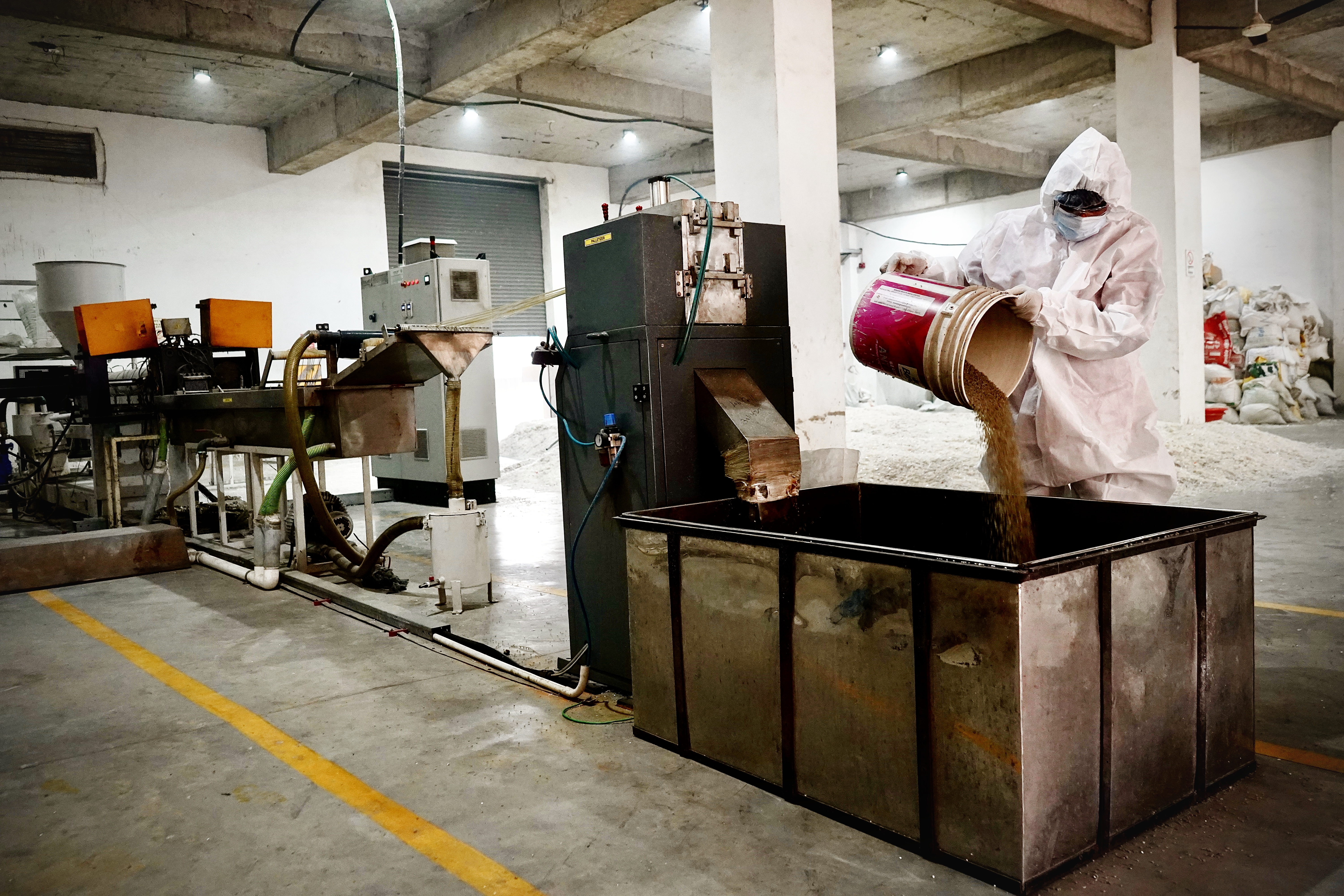 Worker Adding Material to Production Machine