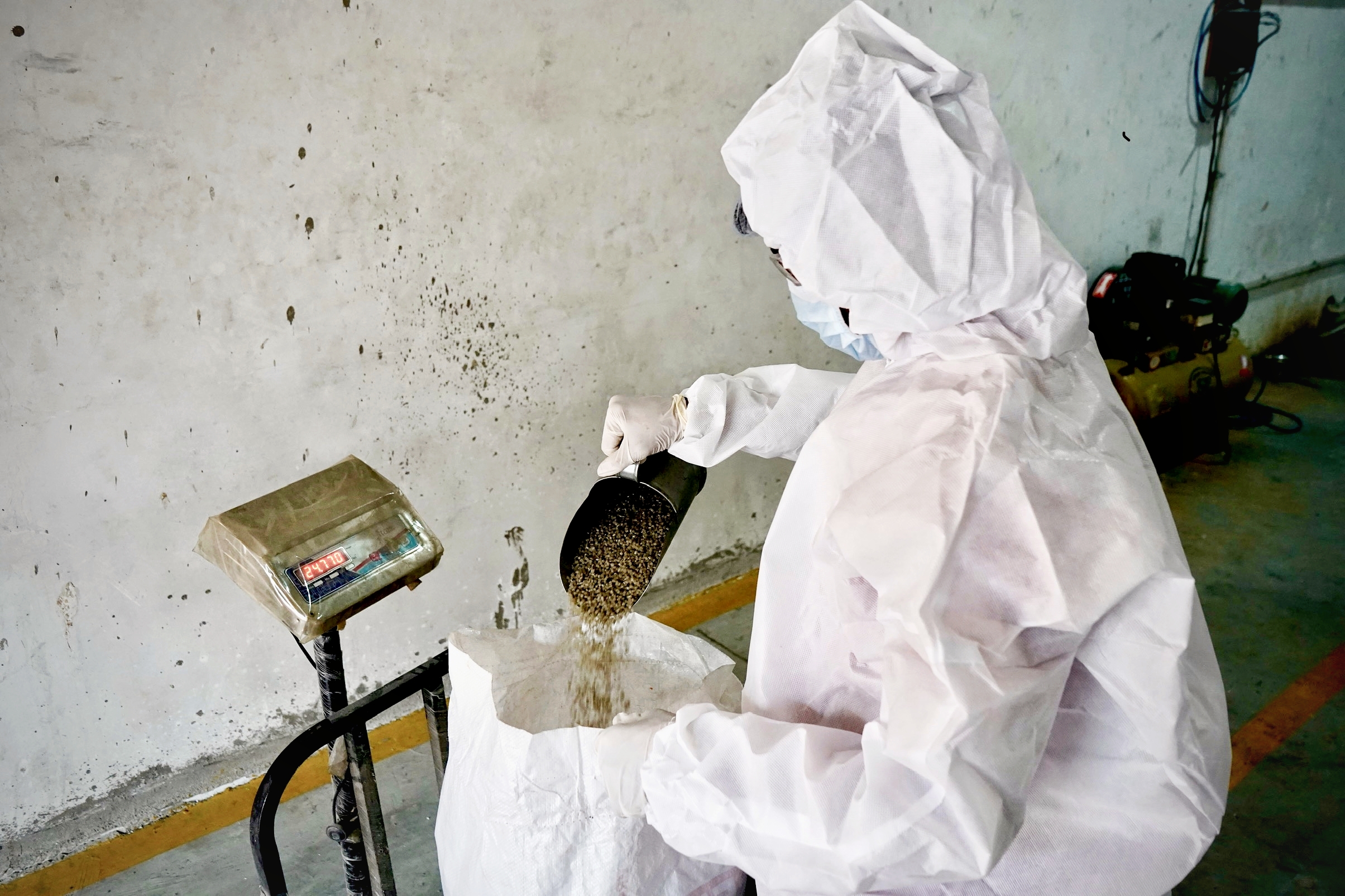 Worker Weighing Material for Production